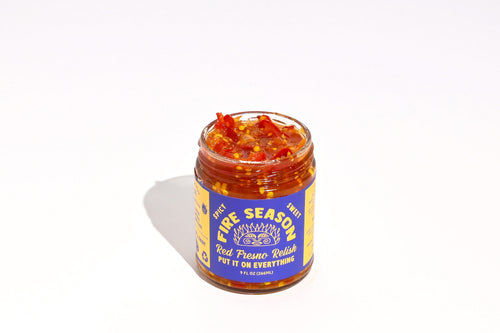 open Jar of Fire Season Red Fresno relish with a blue label on a white background. Sweet,  spicy, pickled condiment. Best chili, best relish. Chunky!